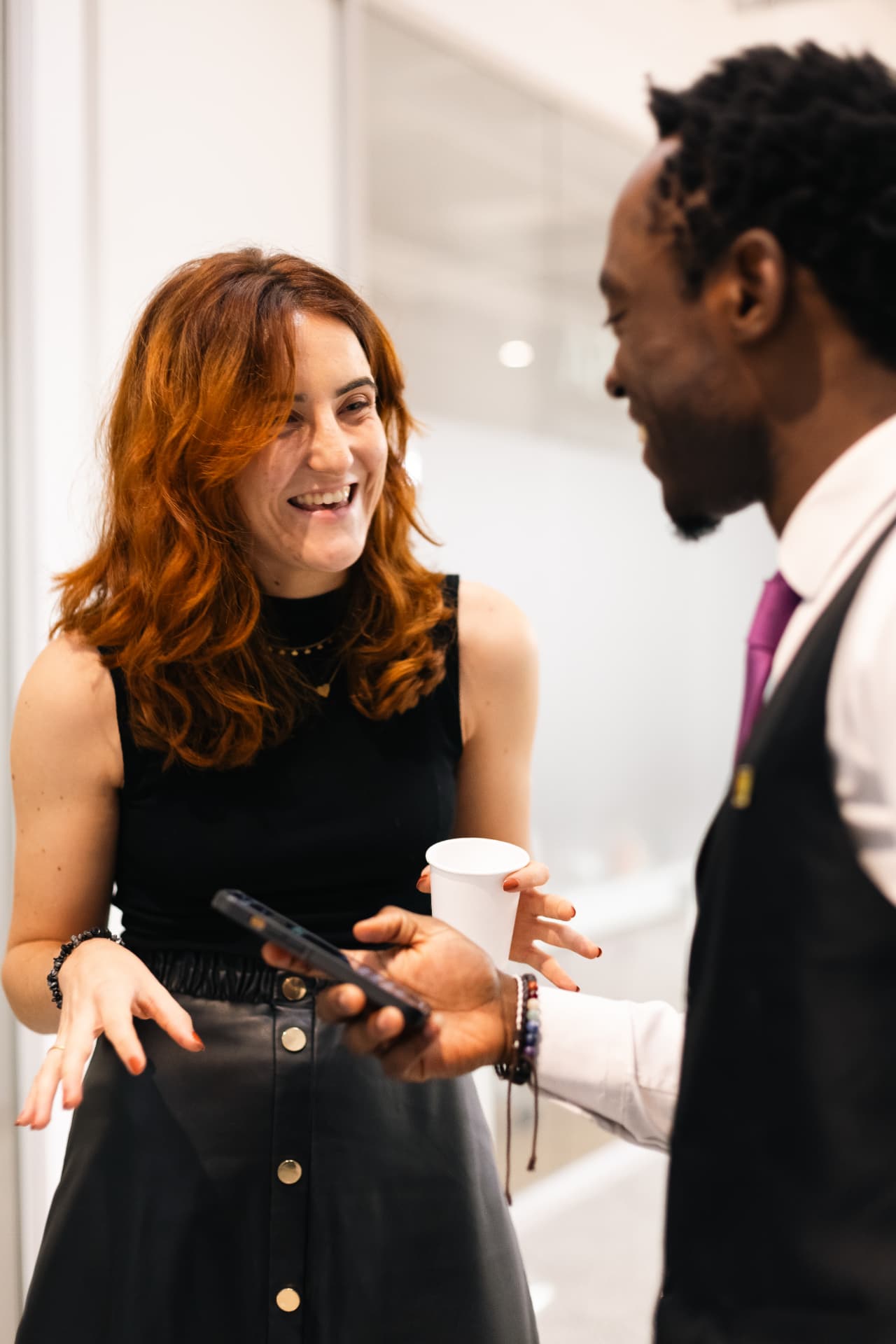Steven Dossou speaking with a founder at an event