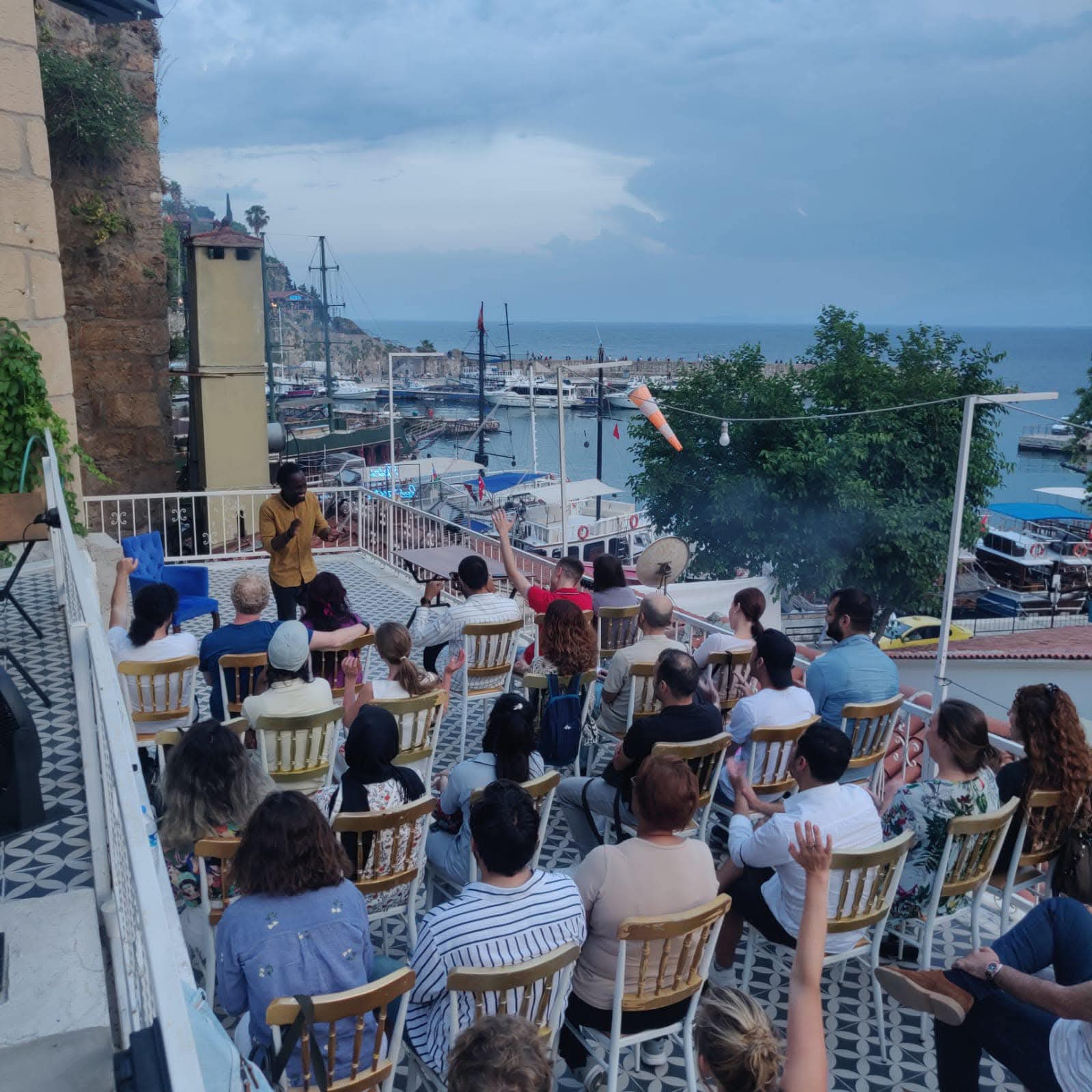 Steven Dossou leading an open-air session above Antalya harbour